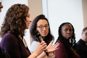 woman talking into microphone at a convening