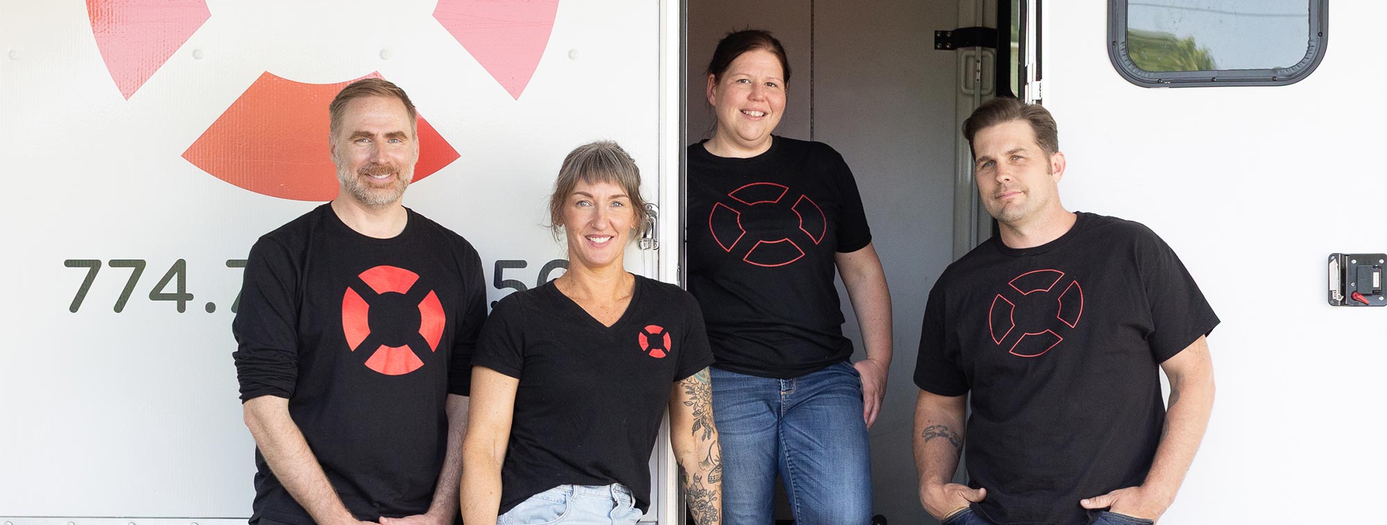 Staff standing in front of the AIDS Support Group of Cape Cod mobile van